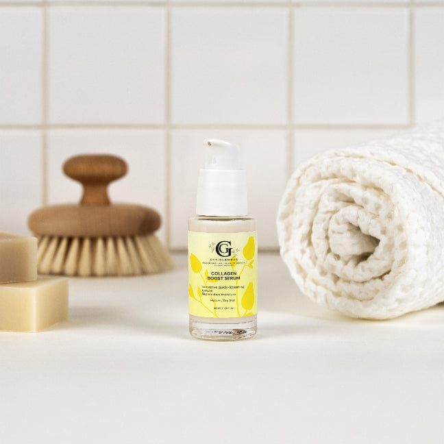 Skincare bottle with a yellow label on a bathroom counter with a towel and brush in the background.